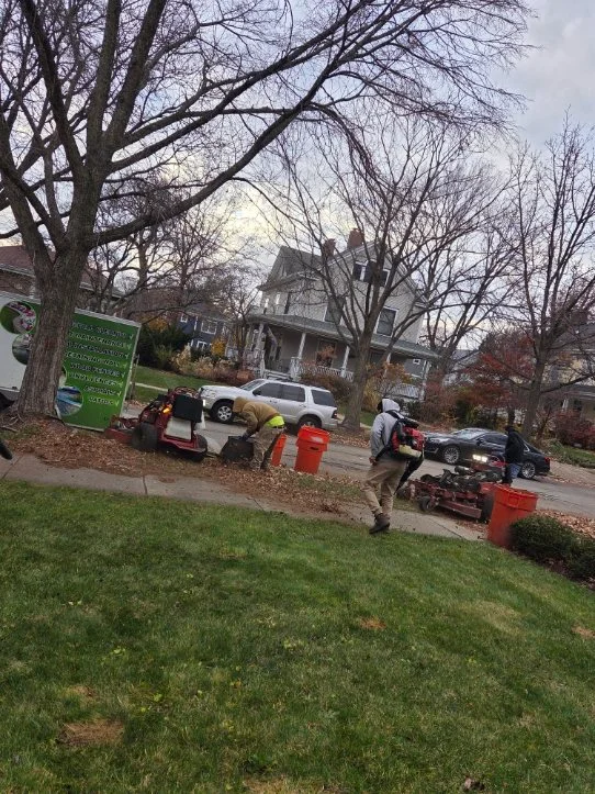 Fall cleanup crew working with equipment on residential street