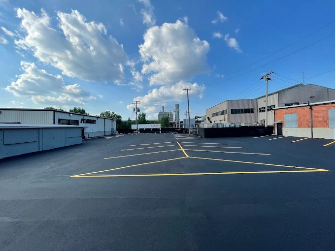 Commercial parking lot asphalt paving with yellow line striping